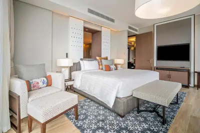 a bedroom with a large bed and a tv at Angsana Oceanview Residences in Laguna by Banyan Living in Laguna Phuket