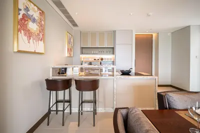 a kitchen with a counter and stools in a room at Angsana Oceanview Residences in Laguna by Banyan Living in Laguna Phuket