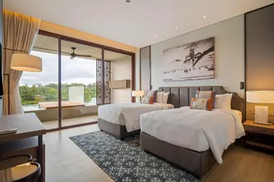 a hotel room with two beds and a large window at Angsana Oceanview Residences in Laguna by Banyan Living in Laguna Phuket