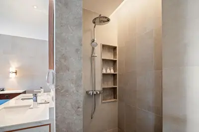 a bathroom with a shower and a sink at Angsana Oceanview Residences in Laguna by Banyan Living in Laguna Phuket