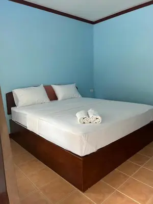 a bed with two rolled up towels on it at อดัมบังกะโล in Ao Nang Beach