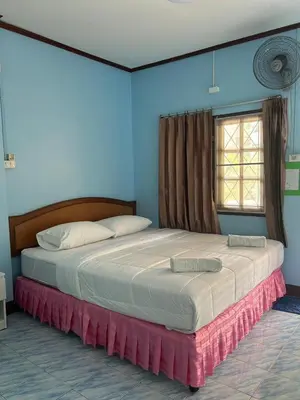 a bedroom with two beds and a window at อดัมบังกะโล in Ao Nang Beach