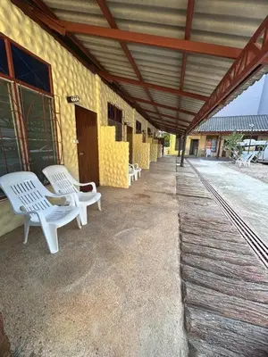 a group of white chairs sitting on the side of a building at อดัมบังกะโล in Ao Nang Beach