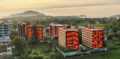 an aerial view of buildings in a city at Stunning 60 sqm Studio at NaiHarn Beach Condo, Walk to Beach, Your Tropical Retreat! in Rawai Beach