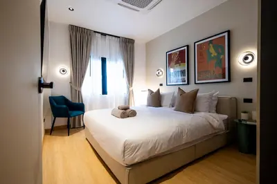 a bedroom with a bed with a teddy bear on it at 5BR Modern Luxury Pool Villa Patong TPSV140 in Patong Beach