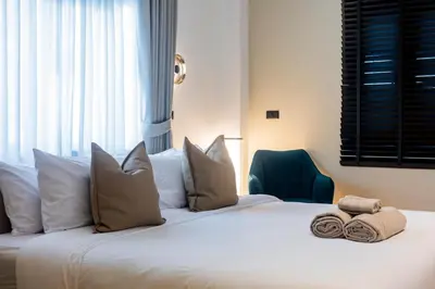 a bedroom with a large white bed with pillows at 5BR Modern Luxury Pool Villa Patong TPSV140 in Patong Beach