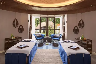 a room with two beds and a table and chairs at Keemala - Tent Pool Villa in Kamala Beach