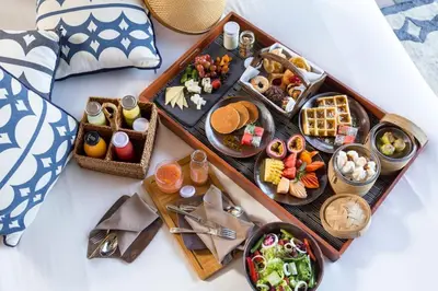 a tray of food on a table with different foods at Keemala - Tent Pool Villa in Kamala Beach