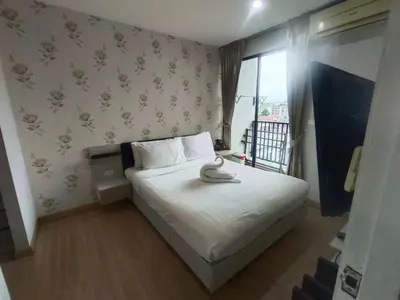 a small bedroom with a bed and a window at Zcape Condotel Bangtao Beach in Bang Tao Beach