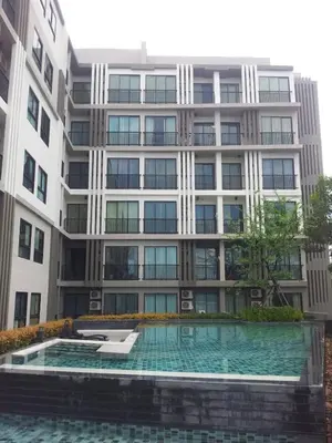 a building with a swimming pool in front of it at Zcape Condotel Bangtao Beach in Bang Tao Beach