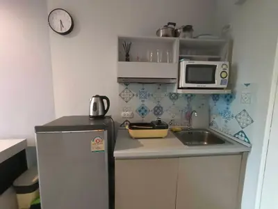 a small kitchen with a refrigerator and a microwave at Zcape Condotel Bangtao Beach in Bang Tao Beach