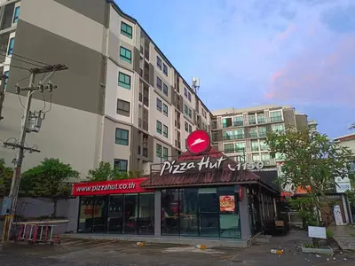 a pizza hut shop in front of a building at Zcape Condotel Bangtao Beach in Bang Tao Beach