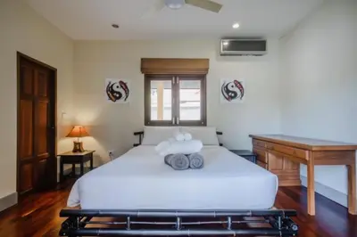 a bedroom with a white bed and a desk at NEW Phuket Residence 2 Bedrooms Charming House in Rawai Beach