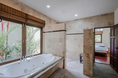 a large bathroom with a tub and a bedroom at NEW Phuket Residence 2 Bedrooms Charming House in Rawai Beach