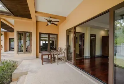 an open living room with a ceiling fan and glass doors at NEW Phuket Residence 2 Bedrooms Charming House in Rawai Beach