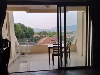 a table and chairs on a balcony with a view at The green golf resident in Kathu