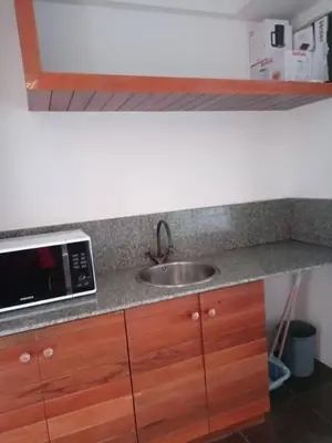 a kitchen counter with a sink and a microwave at The green golf resident in Kathu