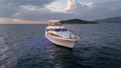 a white boat in the middle of the water at The Treasure in Patong Beach