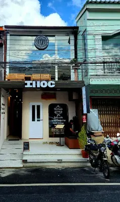 a shop with a motorcycle parked in front of it at IHOC - Phuket OldTown in Ban Lo Long