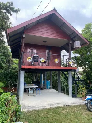 a small house with a deck and a table at thechalethome in Panwa Beach