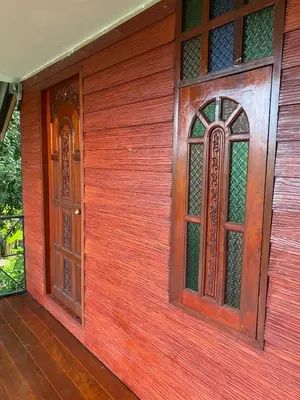 two doors on the side of a house at thechalethome in Panwa Beach