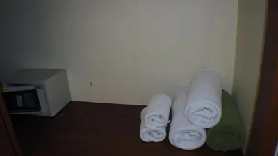 a pile of towels sitting in a corner of a room at Pennapa Chalet in Chalong