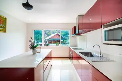 a kitchen with white counters and a large window at \u82ad\u4e1cvilla3\u56db\u5367\u6d77\u666f\u6cf3\u6c60\u522b\u5885\u82ad\u4e1c\u6d77\u6ee9\u8fd1\u73ed\u8d5eBangla in Patong Beach