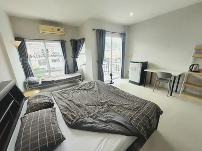 a bedroom with a bed with a blanket on it at Room Phuket Town by Alissa in Ban Phlu Yai