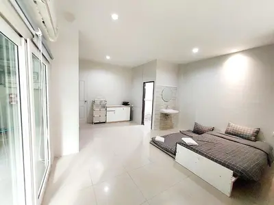 a bedroom with a bed in the middle of a room at Room Phuket Town by Alissa in Ban Phlu Yai