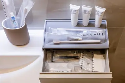 a drawer with toothbrushes and other items in it at Karon Beach Residence in Karon Beach