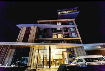 a building with a car parked in front of it at Aristo Resort M08 Surin Beach in Surin Beach