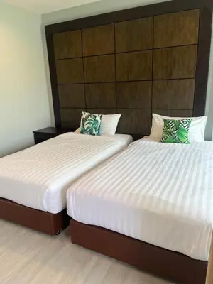 two beds in a hotel room with two beds sidx sidx sidx at Afiyath Residence in Kamala Beach