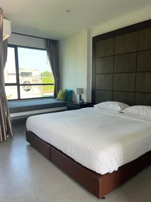 a bedroom with a large bed and a large window at Afiyath Residence in Kamala Beach