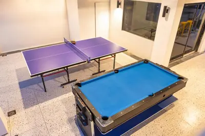 a purple ping pong table in a room at Mellow Poshtel - Kata Beach in Kata Beach