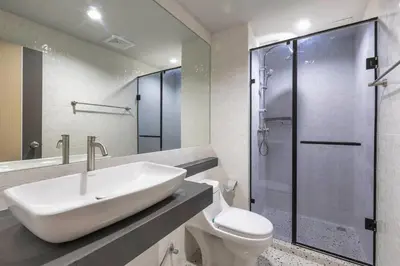 a bathroom with a sink and a shower at Mellow Poshtel - Kata Beach in Kata Beach