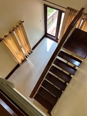 a staircase in a house with a window at Patong Beach\u68ee\u6797\u5c4b111 in Patong Beach