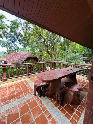 a wooden picnic table sitting on a brick patio at Patong Beach\u68ee\u6797\u5c4b111 in Patong Beach