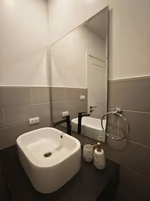 a bathroom with a sink and a large mirror at Karon Beach Large 2 bedrooms & living room Seaview apartment in Karon Beach