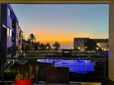 a view of a swimming pool from a balcony at Karon Beach Large 2 bedrooms & living room Seaview apartment in Karon Beach