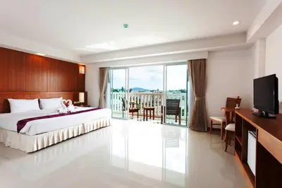 a hotel room with a bed and a television at Rawai Princess Hotel in Rawai Beach