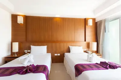 two beds in a hotel room with bows at Rawai Princess Hotel in Rawai Beach