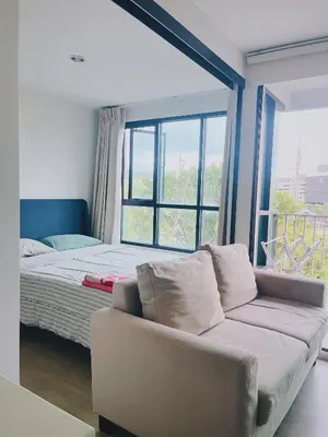 a living room with a couch and a large window at 38Nice room phuket town near Shopping Malls and Naka night market in Phuket Town