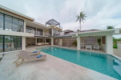 a villa with a swimming pool and a house at ANDAMAN Villa KOH YAO NOI in Ko Yao Noi