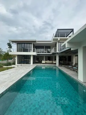 a house with a swimming pool in front of a building at ANDAMAN Villa KOH YAO NOI in Ko Yao Noi