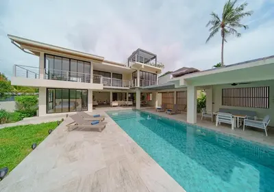 an exterior view of a house with a swimming pool at ANDAMAN Villa KOH YAO NOI in Ko Yao Noi