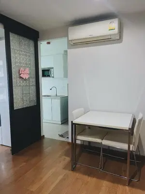 a room with a table and chairs and a kitchen at 02Nice room phuket town near Shopping Malls and Naka night market in Phuket Town