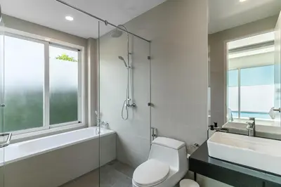 a bathroom with a toilet and a tub and a sink at Friendly Kamala Garden View in Kamala Beach