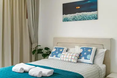 a bedroom with a bed with towels on it at Friendly Kamala Garden View in Kamala Beach