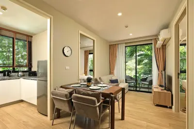 a kitchen and dining room with a table and chairs at Apartment 2 BDR Bangtao #2206 in Phuket