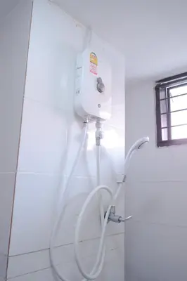 a shower in a bathroom with a hose at XX GO INN Patong Beach หาดป่าตอง in Patong Beach